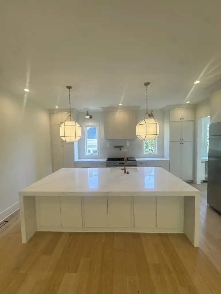 White statement kitchen island with waterfall edges
