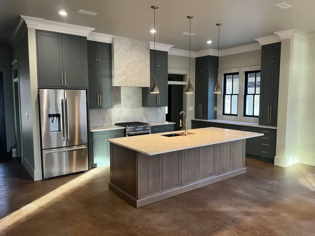 Warm natural kitchen with a wood island and white stone countertops